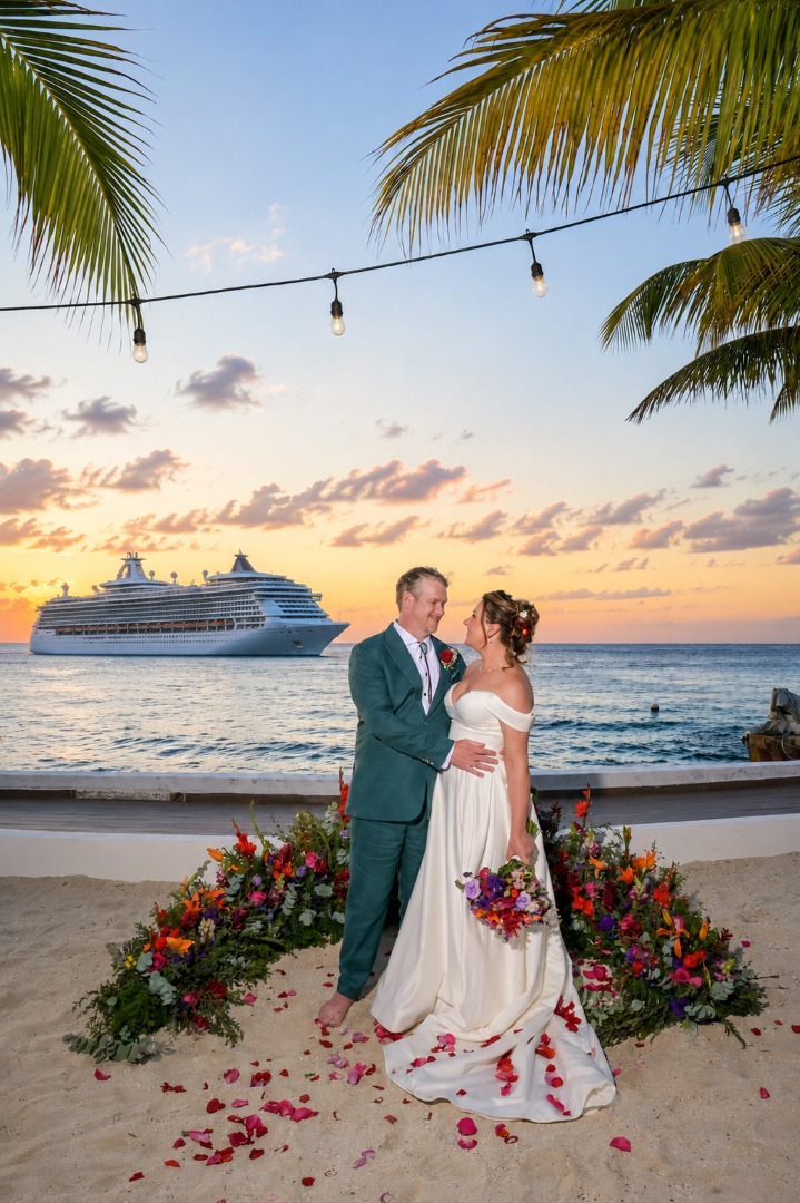 Bride and Groom at a Cozumel beach wedding with a cruise ship in the background